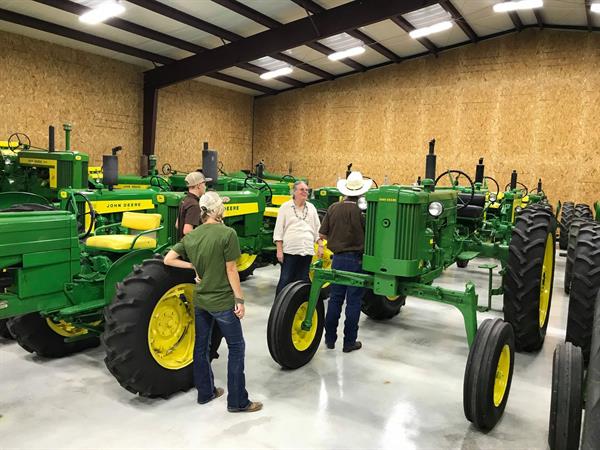 Hired Hand customers Teresa Sparger, Red McCombs Ranch and Kaitlyn Moss, Moss Longhorns admiring Lynn's John Deere tractor collection. Hired Hand customers Teresa Sparger, Red McCombs Ranch and Kaitlyn Moss, Moss Longhorns admiring Lynn's John Deere tractor collection.